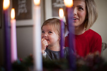 mother and daughter looking at an Advent wreath 