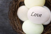 word love on an Easter egg in a bird's nest