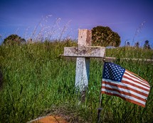 American flag beside a grave