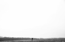 man standing in an open field