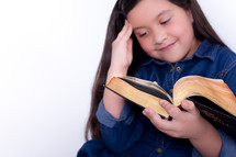 Girl reading the Bible.