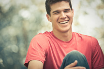 smiling man in a red t-shirt