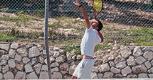 Slow motion of a tennis player hitting the ball during a tennis game