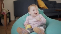 Cute baby playing at home and smiling to the camera