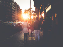 people walking on a sidewalk and intense sunlight 