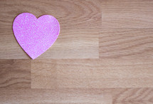 pink heart on wood background 