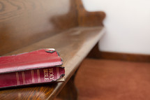 Bible on a church pew.