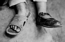 Child wearing different shoes on each foot