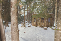 cabin in the woods in the snow 