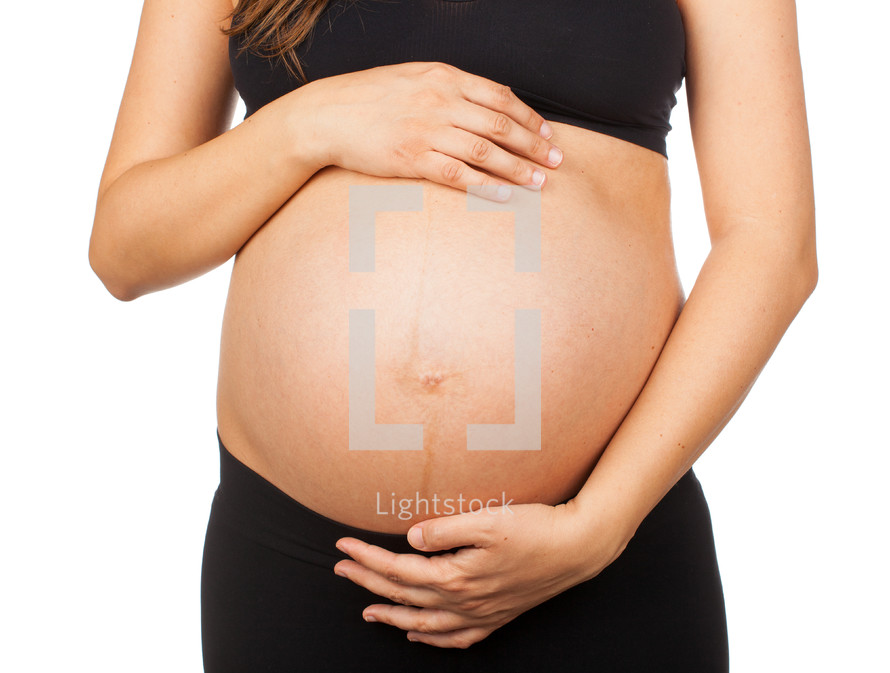 Belly of a pregnant woman on white background