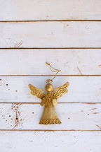 gold angel on white shiplap 