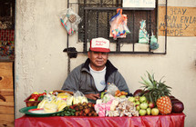Man selling fruit on table