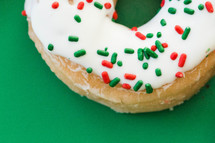 closeup of a sprinkled Christmas donut 