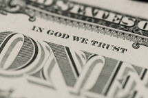 Closeup of a dollar bill showing "In God We Trust"