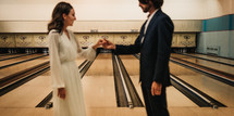 bride and groom in a bowling alley 