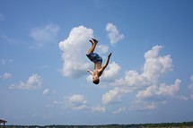 boy doing flip - sky background