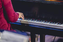 Close up of a woman playing the piano for a church worship service.