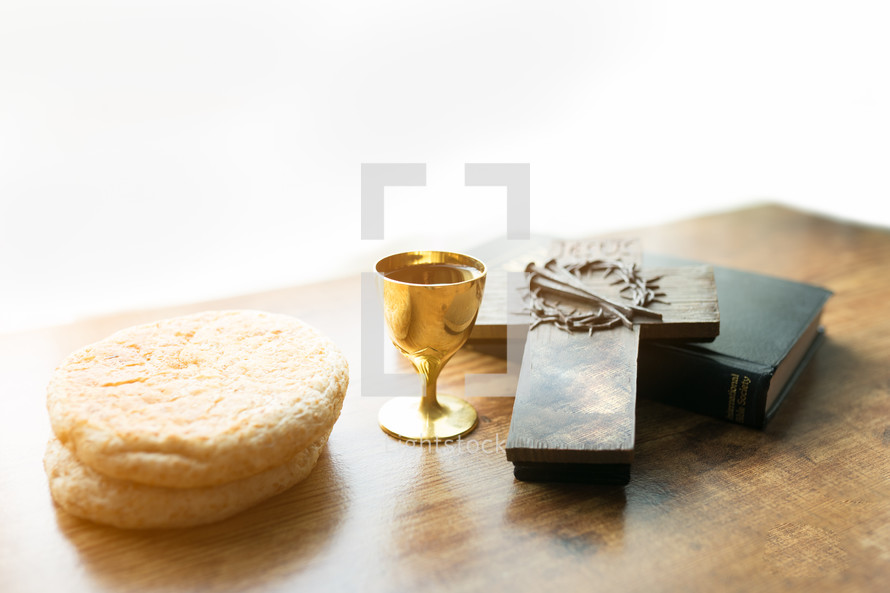 communion bread and wine, with Bible and cross 