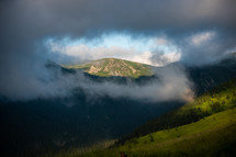 mountain peak through a break in the clouds 