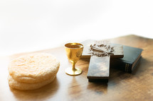 communion bread and wine, with Bible and cross 