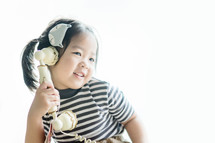 little girl talking on an antique phone 