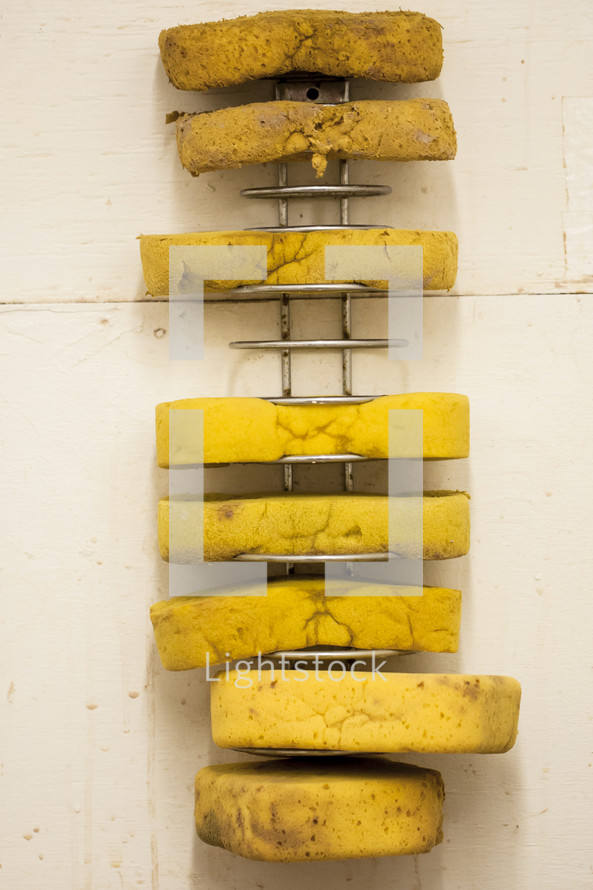 pottery artists sponges on a rack 