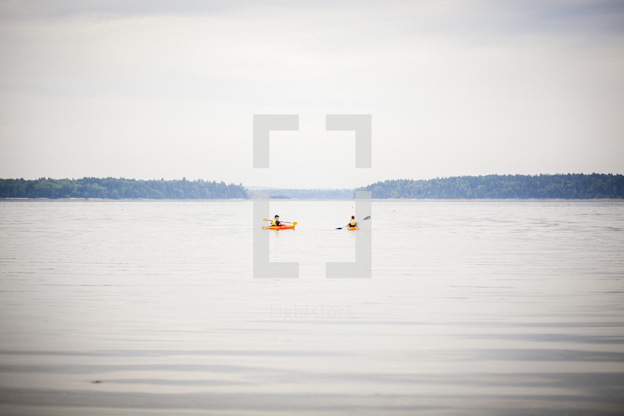 kayakers paddling on a lake