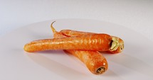 Carrots rotating on white background - close up
