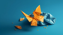 Orange origami butterfly on a blue background with crumpled paper. 