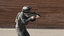 Slow motion of soldier shooting automatic rifle in a range