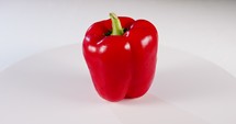 close up a Red bell pepper rotating on a white background
