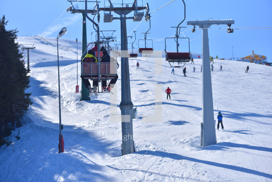 Slope-Side View - Elevated Shot of Skiers and Chairlifts in the Heart of the Winter Sports Action