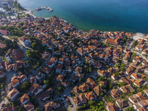 aerial view over a tile roof homes in a coastal community 