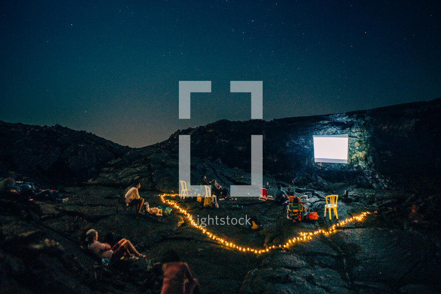 projection screen on a rock at a campsite on a mountain 