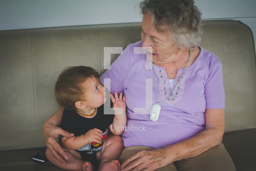 a grandmother sitting with her infant grandson 