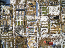 aerial view over snow on farmland 