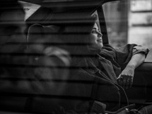 a woman riding in the backseat of a car 