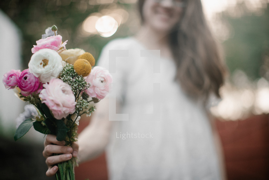 a teen girl holding a bouquet of flowers 