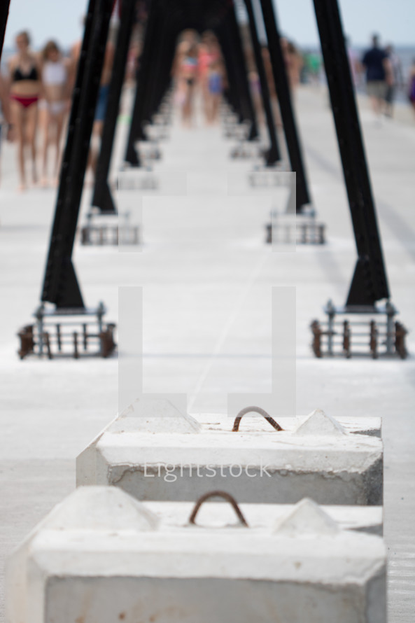 Abstract repetition shot of catwalk beams on the pier with people walking in background at Grand Haven State Park in Grand Haven, Michigan, western Michigan, Lake Michigan, Great Lakes