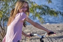 smiling girl on a bike 