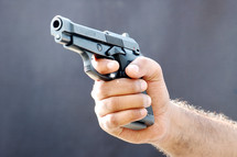 man holding a hand gun 