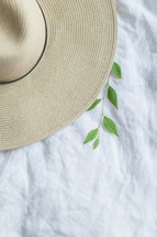 straw hat and plant sprig 