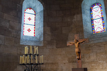 crucifix and candles in a chapel 