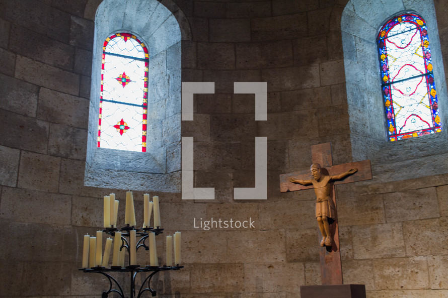 crucifix and candles in a chapel 