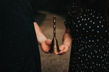 couple holding a bell 