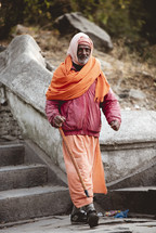 elderly man walking down steps in Nepal 