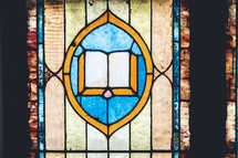 stained glass window with Bible 