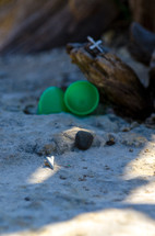 plastic Easter egg and a cross in the sand