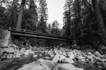 Bridge over rocky stream - black and white