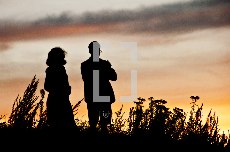 couple standing outdoors at sunset